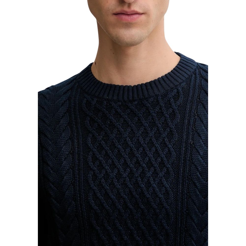Jean Tommy Hilfiger en denim bleu avec sweat-shirt en coton recyclé, visible avec détails de couture et logo de la marque.
