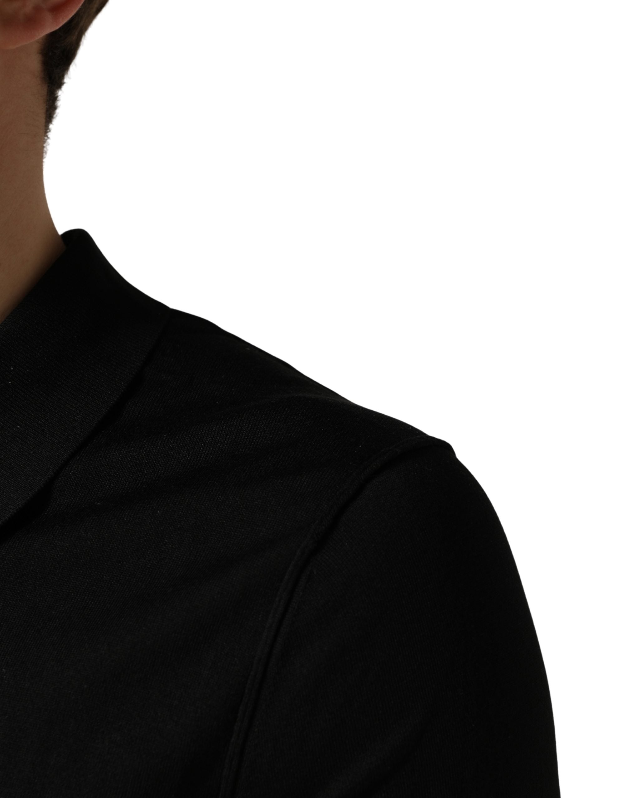 Polo homme Dolce & Gabbana noir en laine à manches courtes, style élégant et classique, vue de face sur fond blanc.