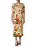 Robe midi en soie beige à pois fruits Dolce & Gabbana, coupe ajustée, avec motifs colorés et design élégant.