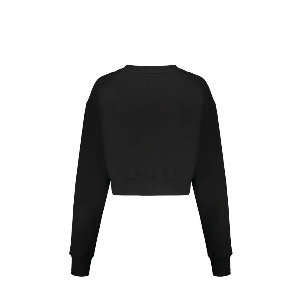 Sweatshirt en coton noir Balmain, coupe décontractée, avec logo Balmain visible sur la poitrine, portée dans un style moderne.