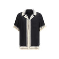 Chemise Dolce & Gabbana à manches courtes en soie multicolore, détails élégants et tissu léger visible sur l'image.