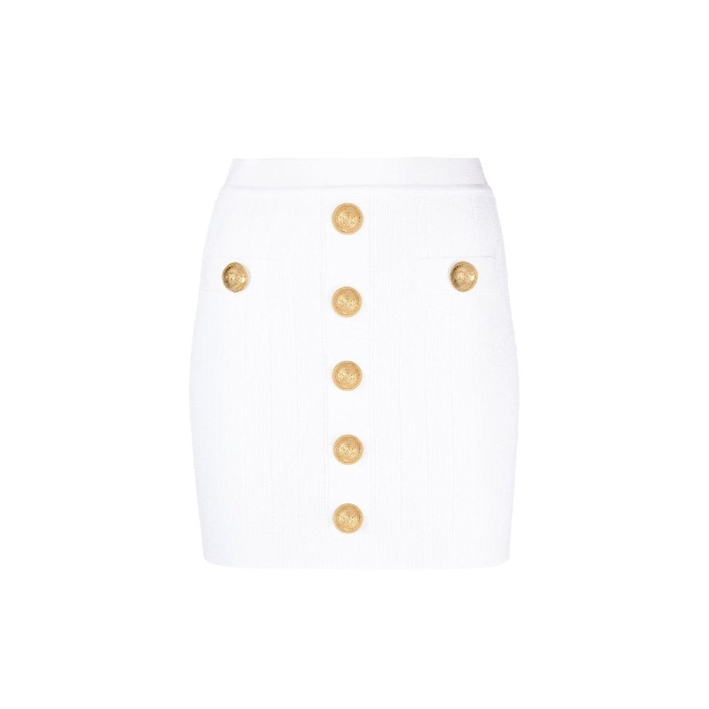 Jupe courte en polyester blanche de la marque Balmain, coupe ajustée, portée avec détails élégants et modernes.