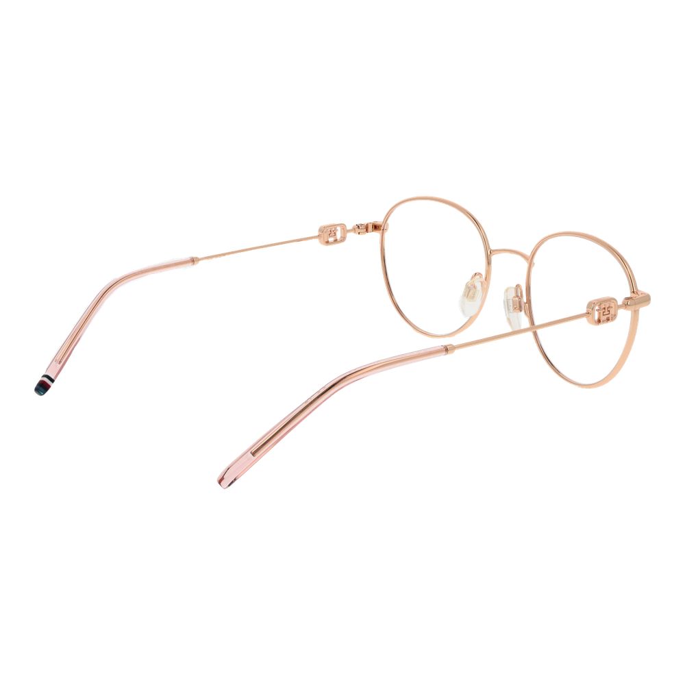 Lunettes Tommy Hilfiger en acier inoxydable doré avec monture élégante, visibles sur l'image.