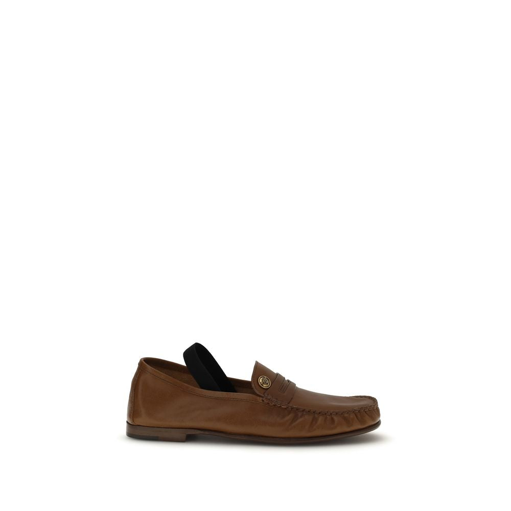 Chaussures mocassins slip-on en cuir marron lamb ovis Aries de Versace, élégantes et confortables, vues de face.