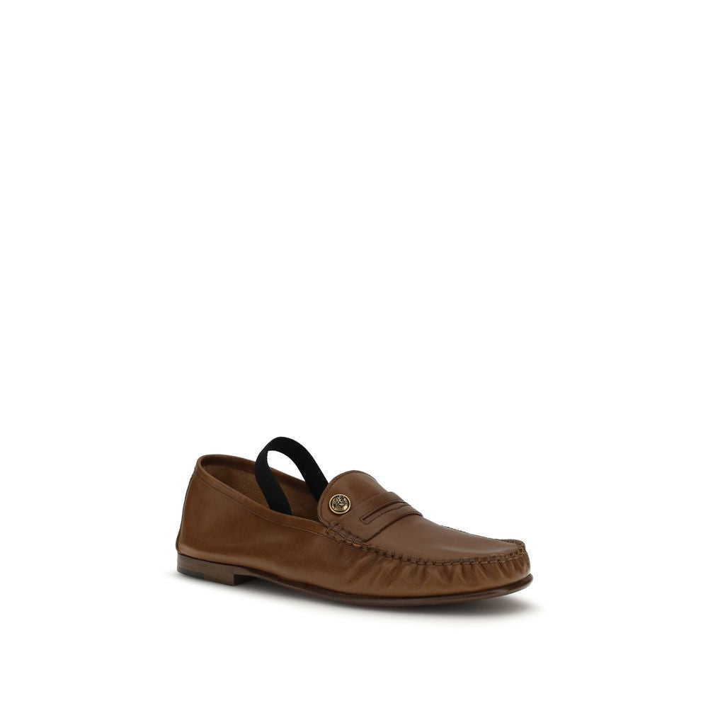 Chaussures mocassins slip-on en cuir brun de mouton ovis Aries pour homme, marque Versace.