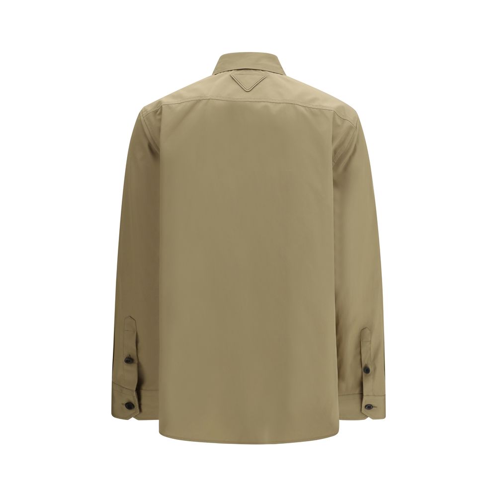 Chemise en coton beige de Prada, vue détaillée du haut avec col et boutons, style élégant et fabrication de luxe.