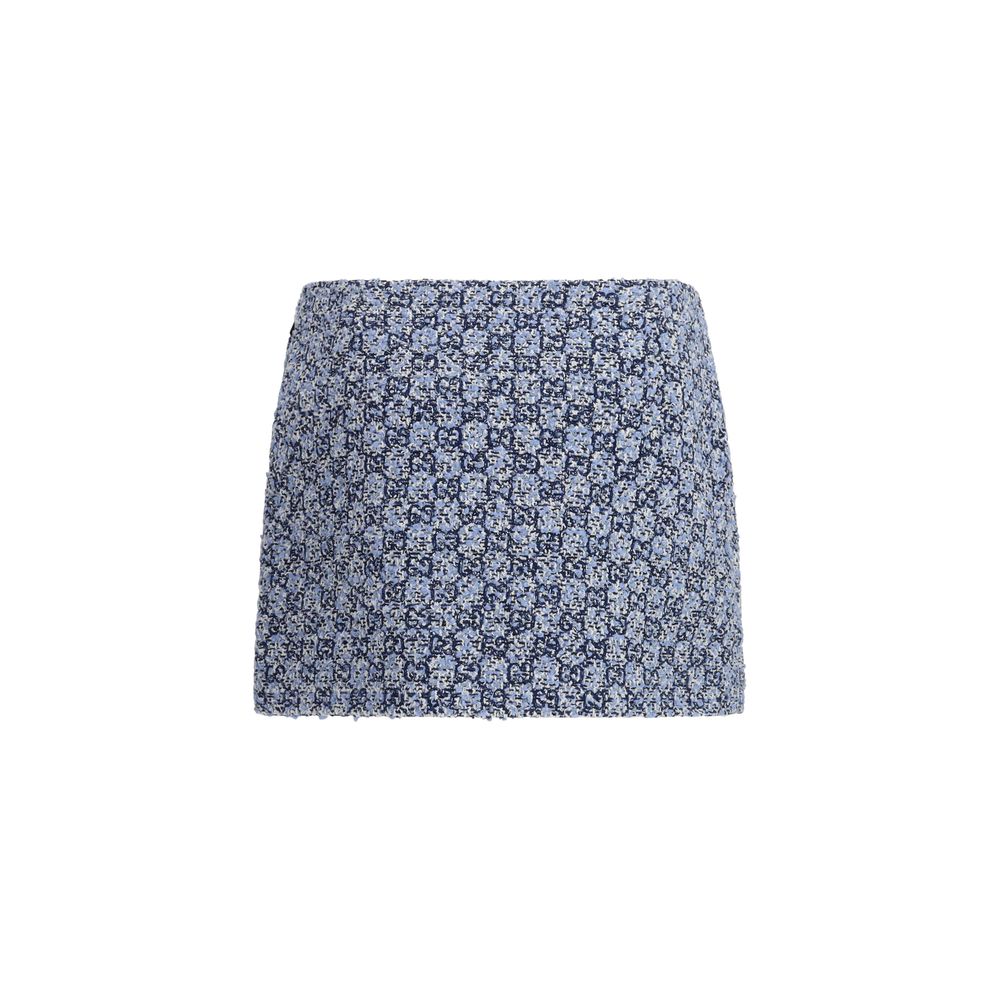 Jupe courte en coton bleu Gucci, style mini, avec détails de mode élégants, portée par un mannequin.