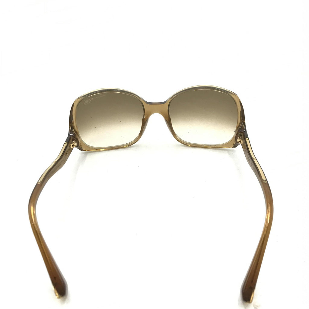 Lunettes de soleil Louis Vuitton avec monture en acétate marron à éclats, style élégant et moderne.