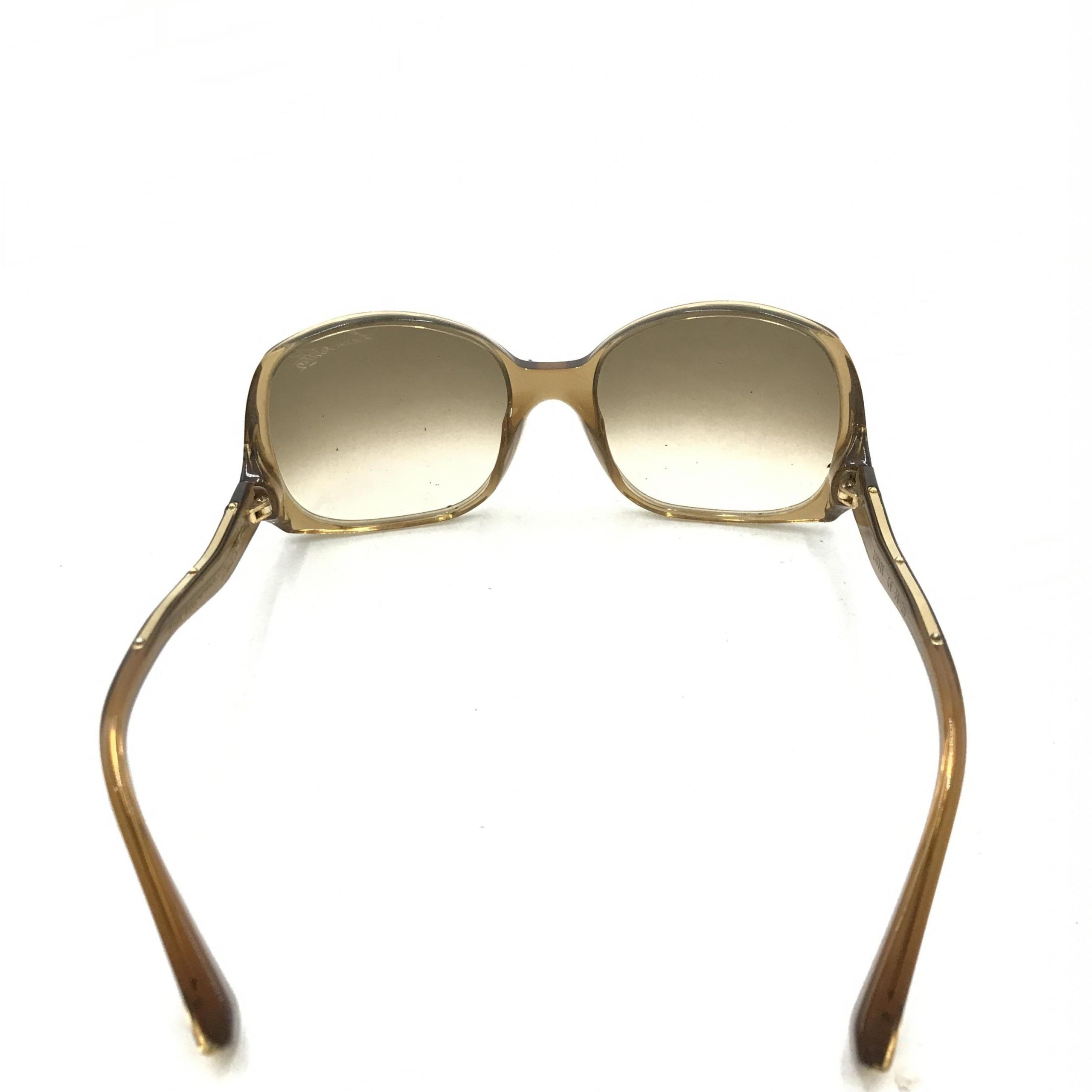 Lunettes de soleil Louis Vuitton avec monture en acétate marron à éclats, style élégant et moderne.