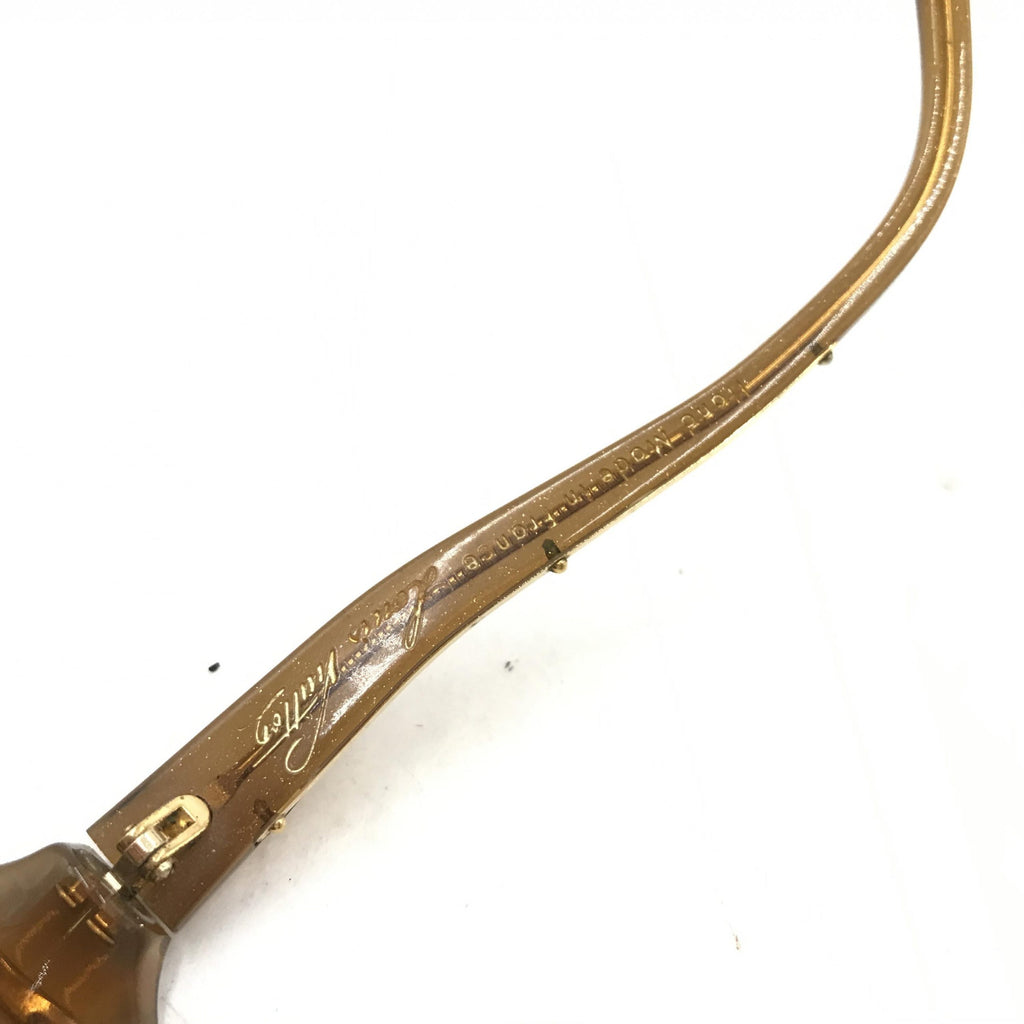 Lunettes de soleil Louis Vuitton en acétate brun avec motifs tachetés, monture élégante et moderne.
