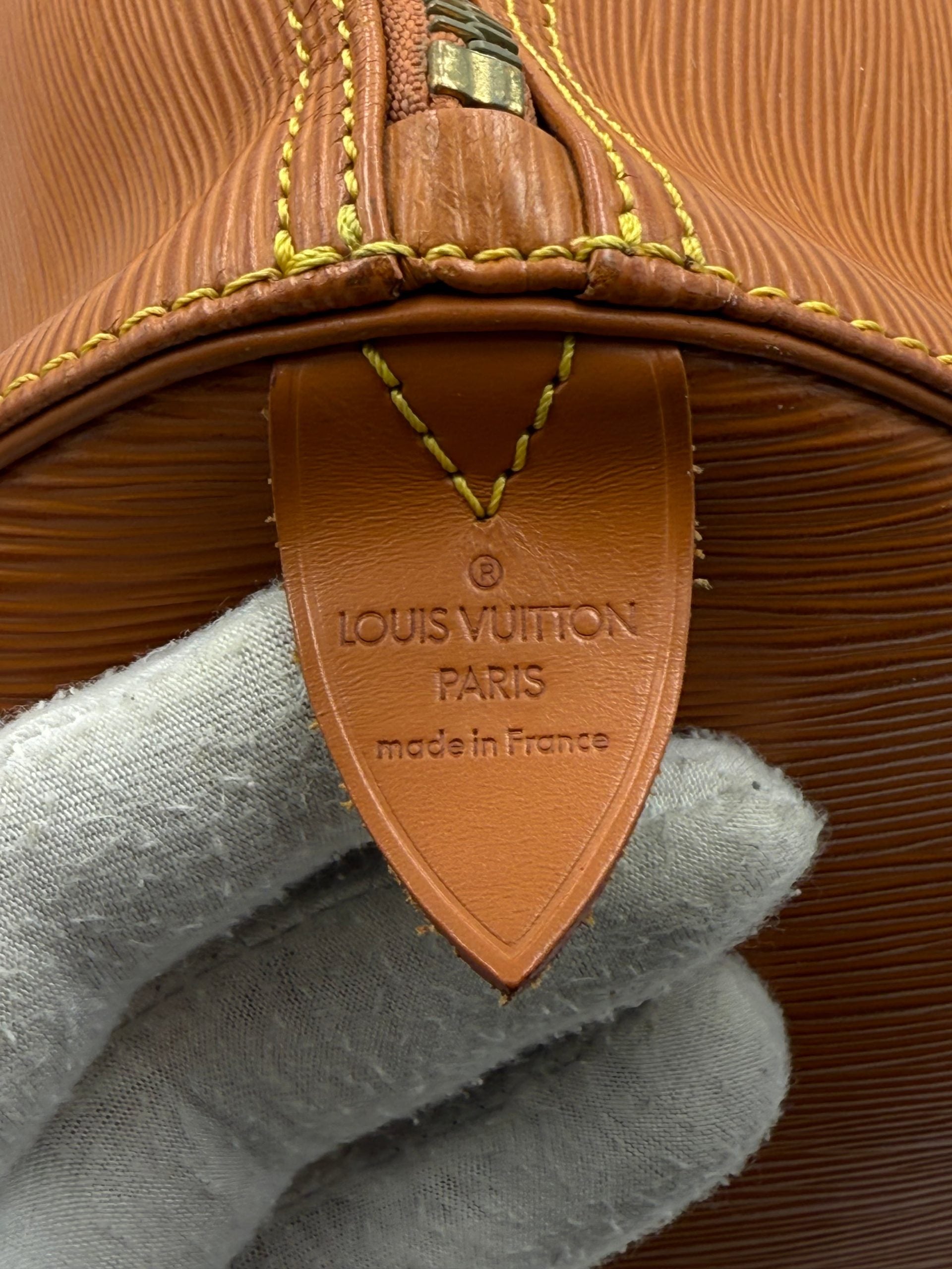 Sac à main Louis Vuitton Keepall 50 en cuir EPI marron, sac de voyage élégant avec poignées et fermeture zippée.