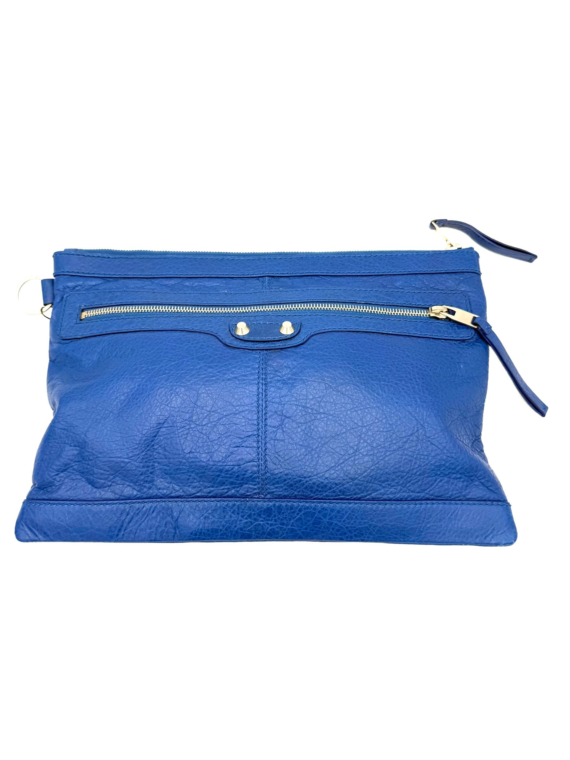 Pochette Balenciaga Le Cagole bleue en cuir avec logo Balenciaga en relief, fermeture éclair et détails modernes.