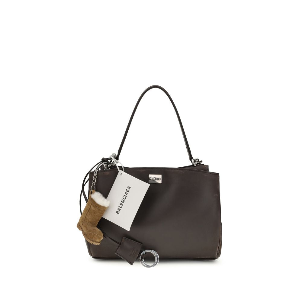 Sac à bandoulière Balenciaga en cuir de veau marron Bos Taurus, élégant et sophistiqué, avec poignées et détails modernes.