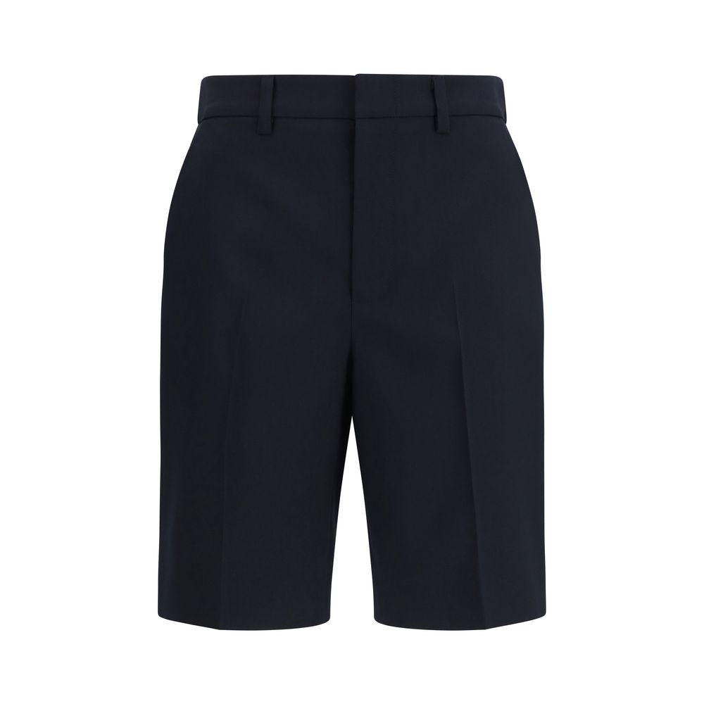 Shorts bermuda en coton noir de Gucci, style décontracté, avec logo Gucci visible sur la ceinture.