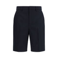 Shorts bermuda en coton noir de Gucci, style décontracté, avec logo Gucci visible sur la ceinture.