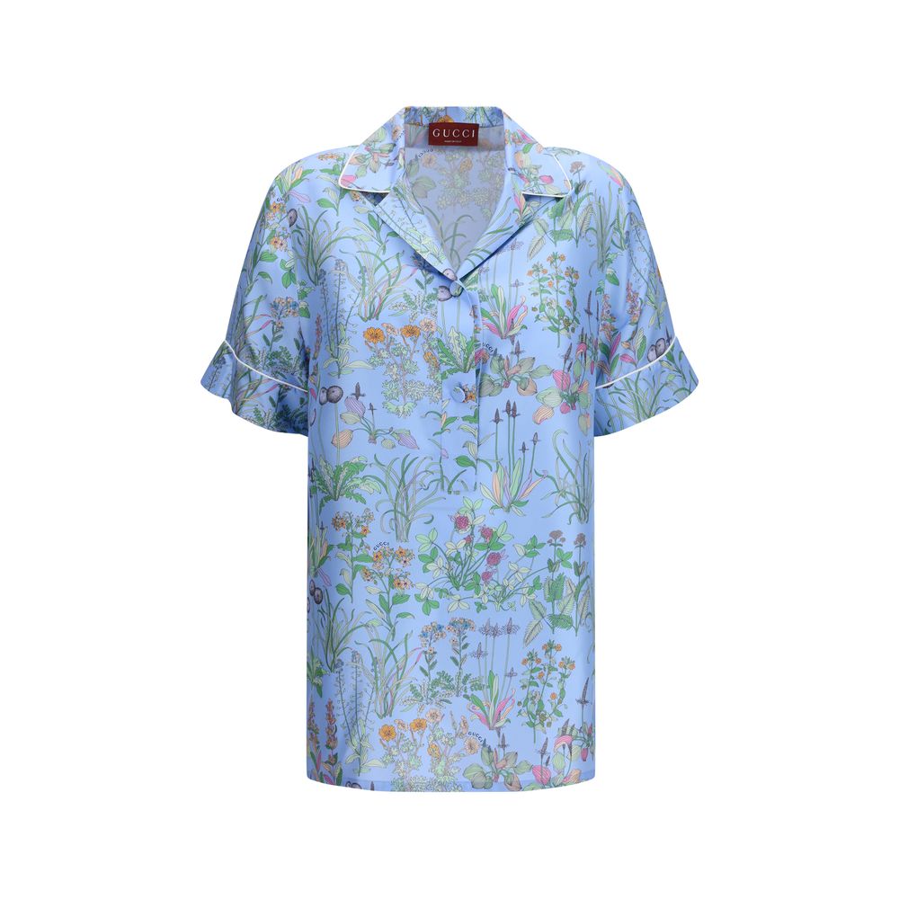 Chemise en soie bleue Gucci avec motif élégant, manches longues et col classique, pour un style sophistiqué et tendance.