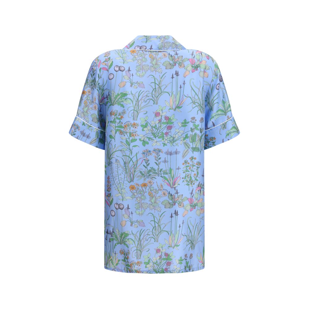 Chemise en soie bleue Gucci avec motif élégant, manches longues et col classique, tissu luxueux et finition soignée.