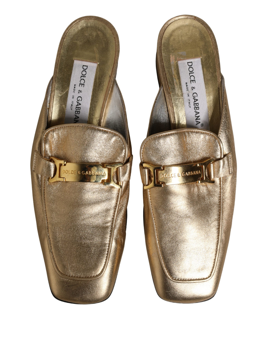 Mules en cuir doré Dolce & Gabbana, chaussures plates et slides élégantes, vues de face avec détails en cuir brillant.