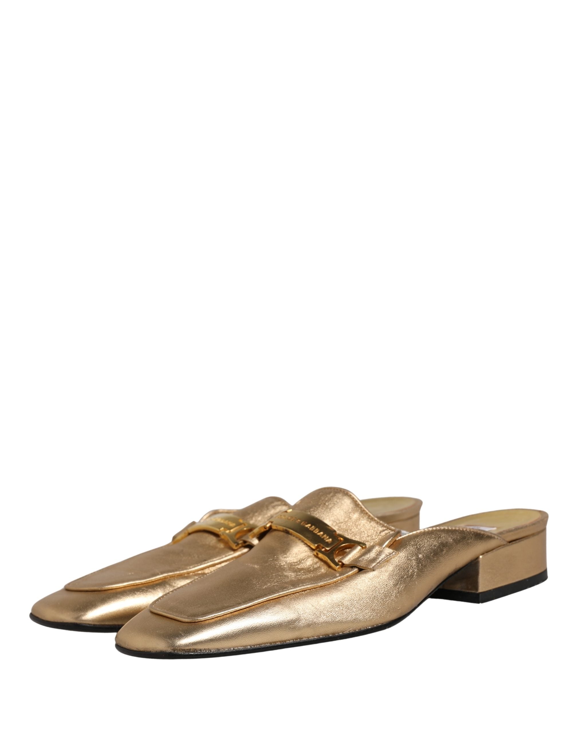 Chaussures Dolce & Gabbana en cuir doré, mules plates à glissière, style élégant et sophistiqué, vues de face sur fond neutre.