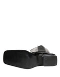 Bottes hautes en cuir verni noir Dolce & Gabbana, chaussures élégantes en cuir brillant, style sophistiqué et moderne.