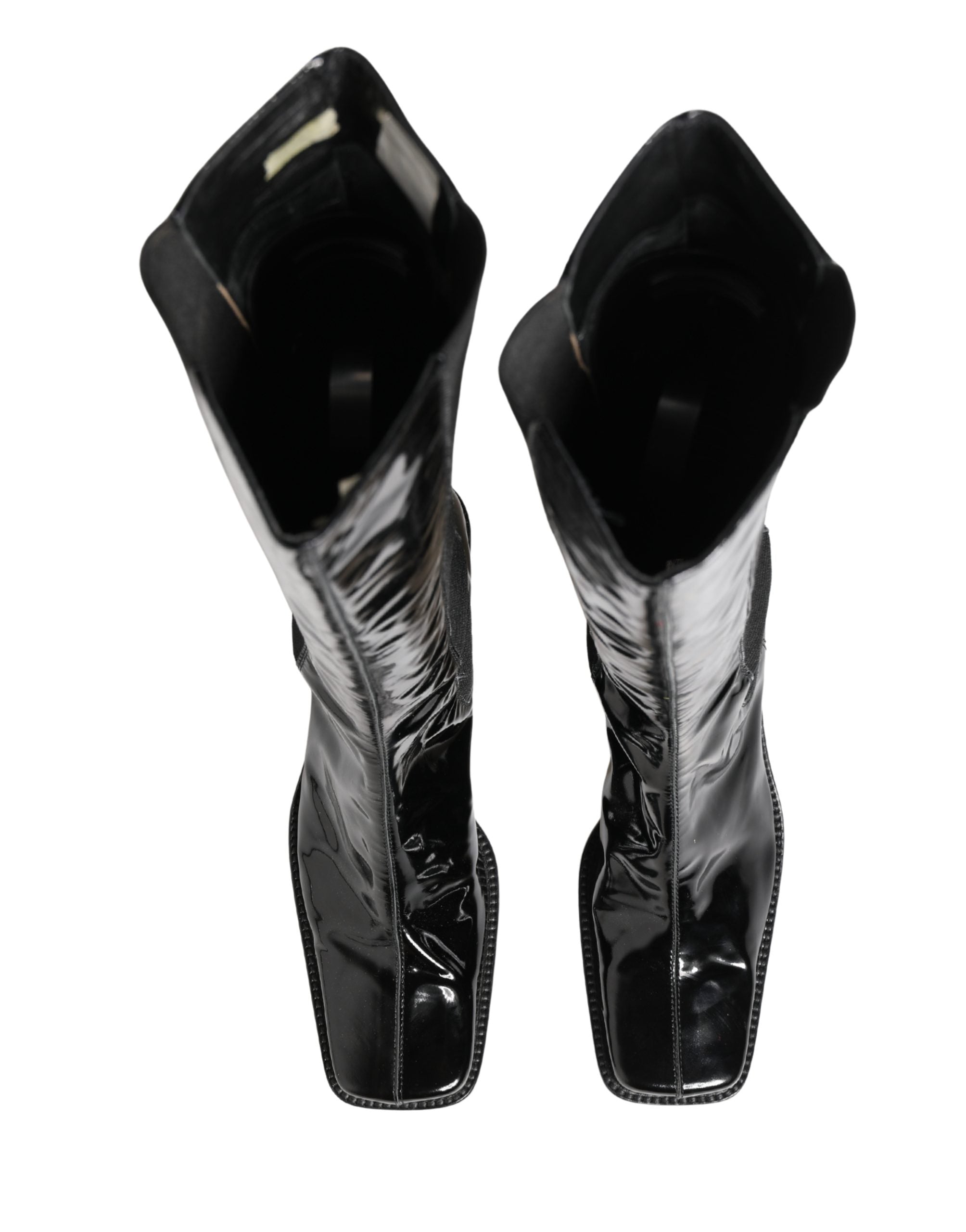 Bottes hautes en cuir verni noir Dolce & Gabbana, chaussures élégantes en cuir brillant, longueur genou, style sophistiqué.