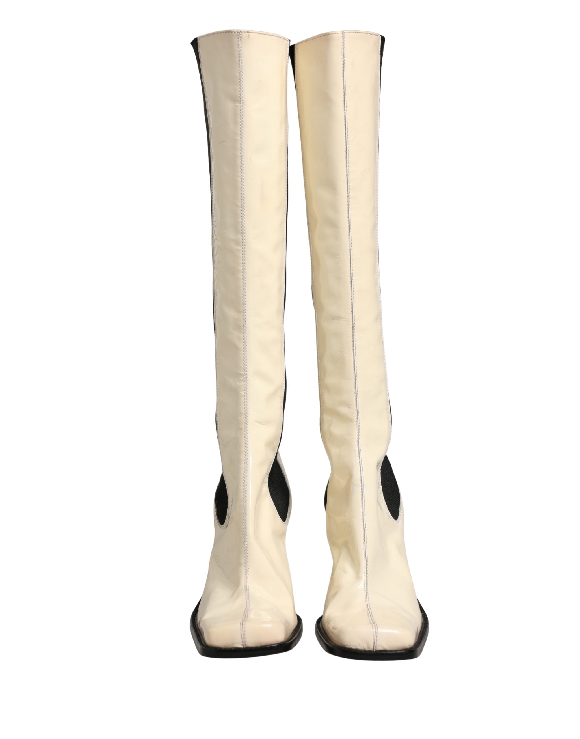 Bottes hautes en cuir blanc et noir de Dolce & Gabbana, chaussures élégantes et sophistiquées.
