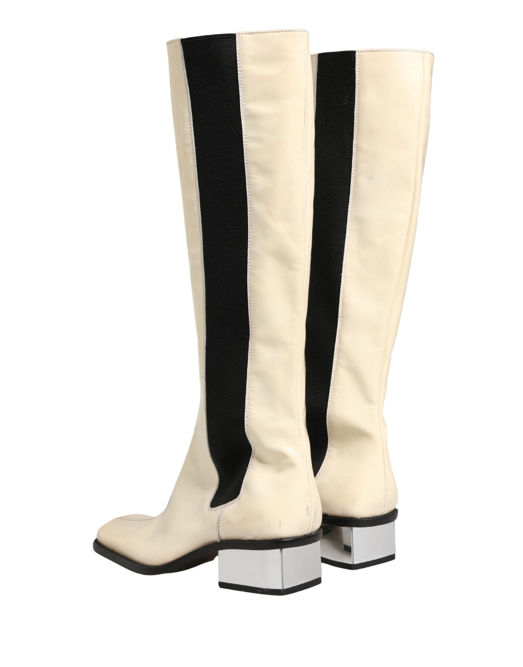 Bottes en cuir noir et blanc Dolce & Gabbana, hautes jusqu'au genou, avec design élégant et finition sophistiquée.