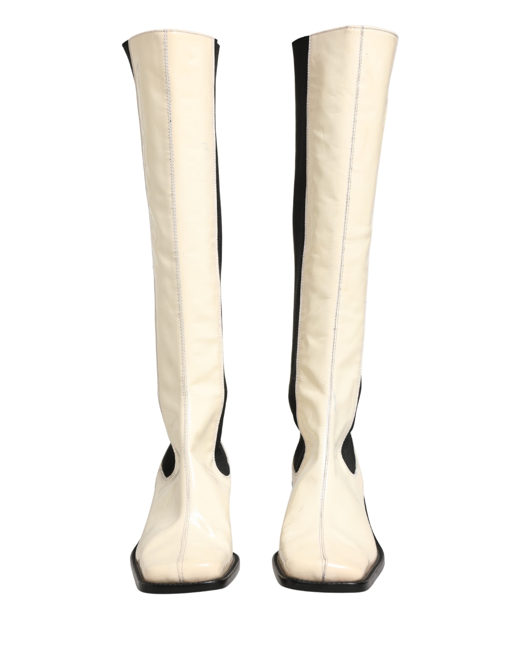 Bottes hautes en cuir blanc et noir de Dolce & Gabbana, chaussures élégantes et sophistiquées pour femmes.