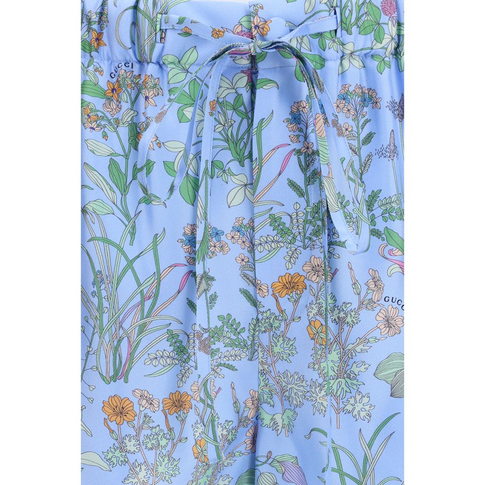 Shorts bermuda en soie bleue de Gucci, coupe élégante avec logo discreet, parfaits pour un look sophistiqué.