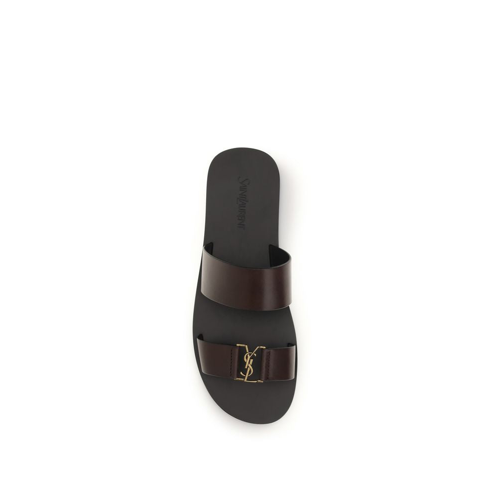 Sandales plates en cuir de veau marron Saint Laurent Bos Taurus, visibles avec semelle et design élégant.
