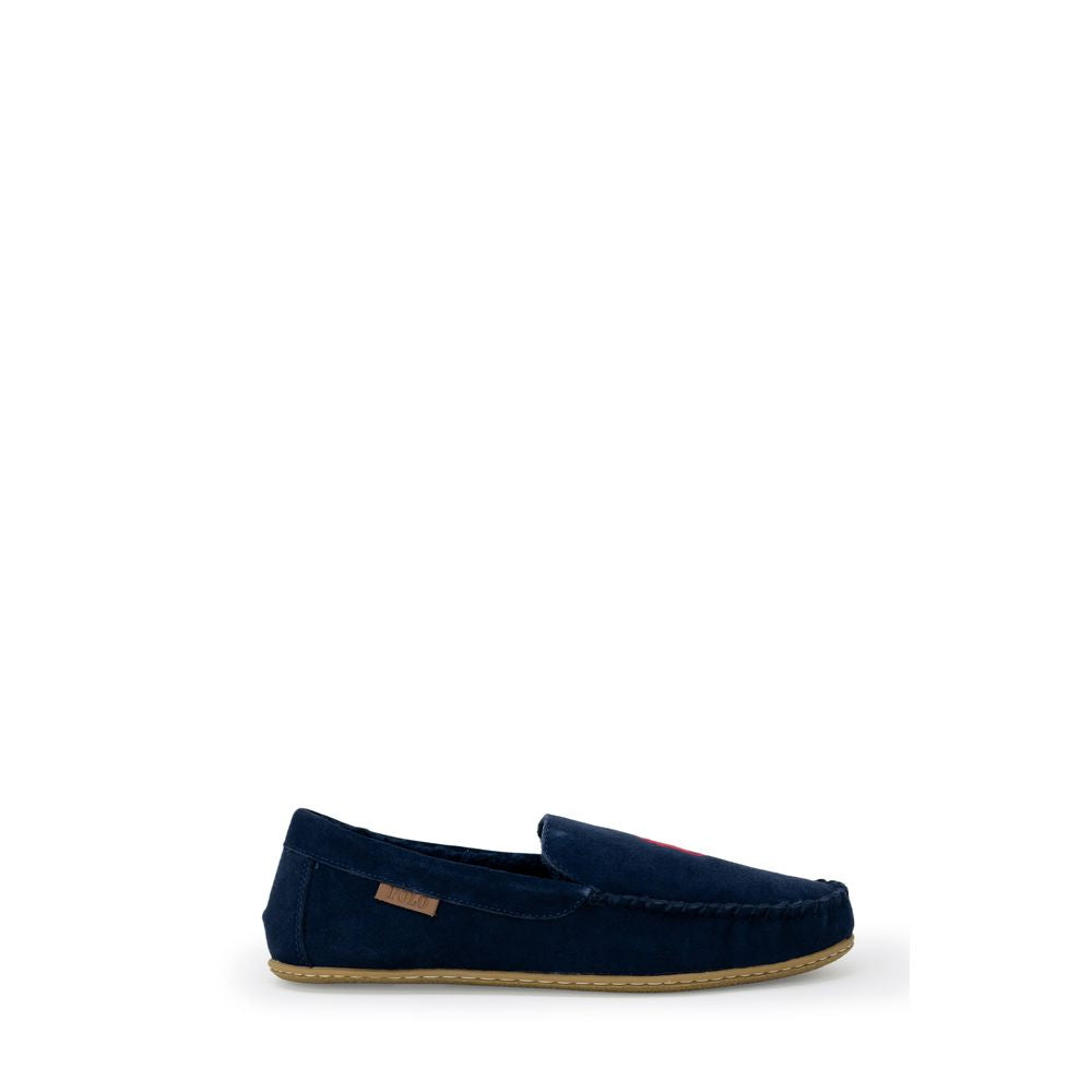 Chaussons en fausse fourrure bleue Ralph Lauren, confortables et élégants pour la maison, avec logo Ralph Lauren visible.