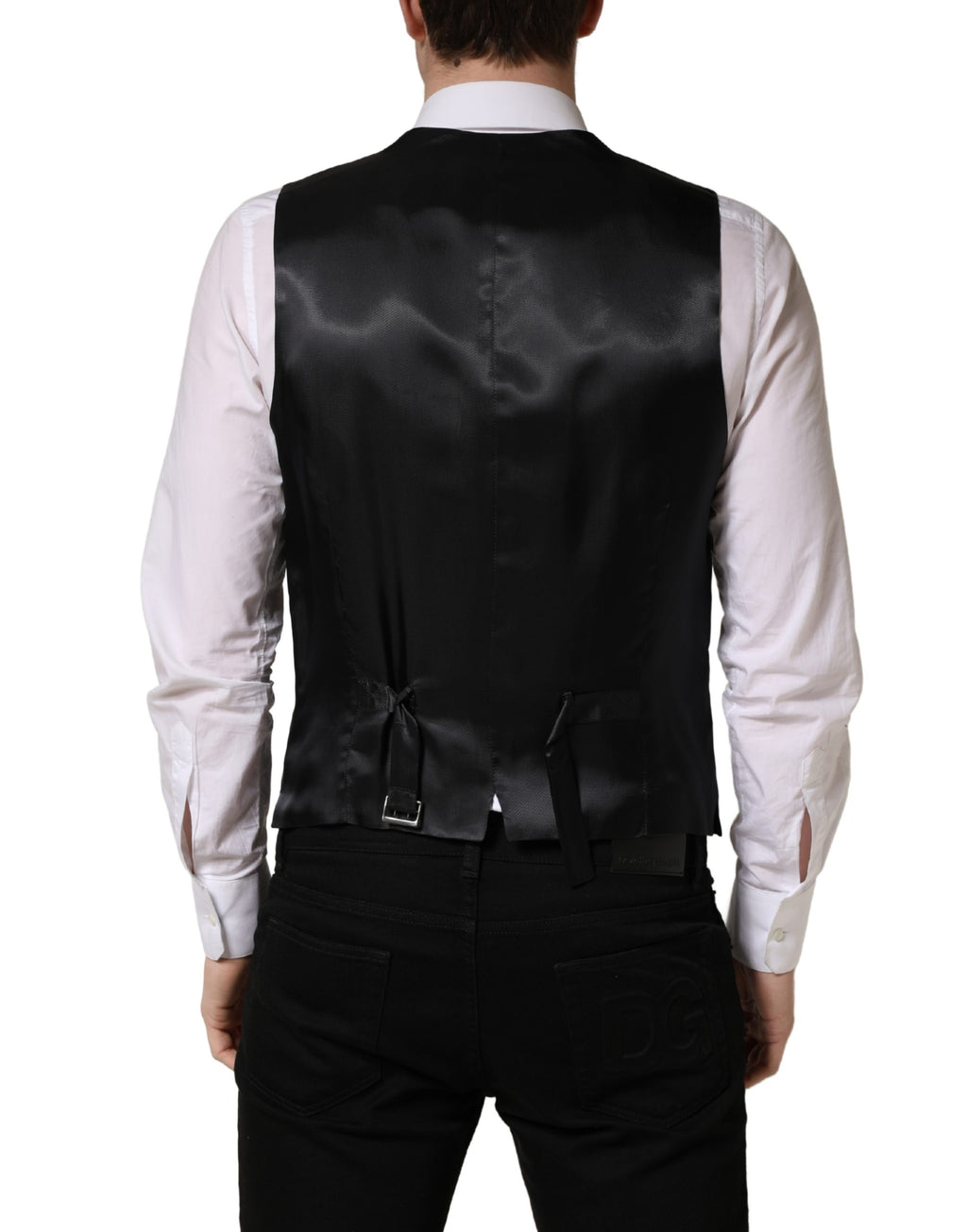 Gilet en laine noir Dolce & Gabbana à simple boutonnage, ajusté, avec col en V, porté sur un fond neutre.