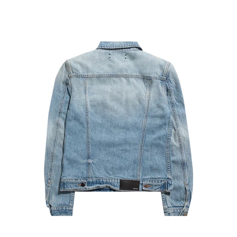 Veste en denim bleu en coton de la marque Amiri, style décontracté avec détails modernes, vue de face sur un fond blanc.