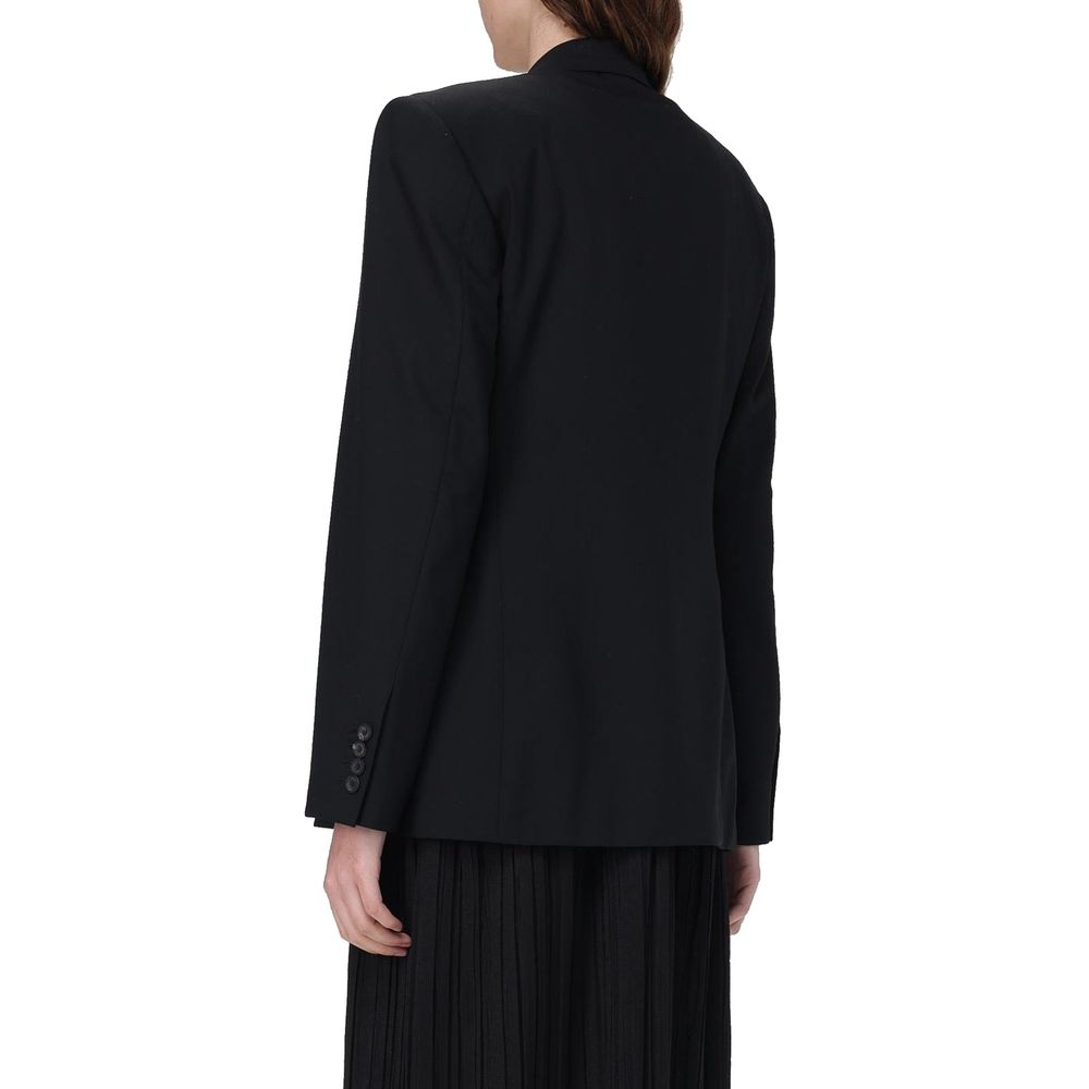 Veste longue en laine noire de Balenciaga, élégante et moderne, portée sur un mannequin, détail de la texture en laine.
