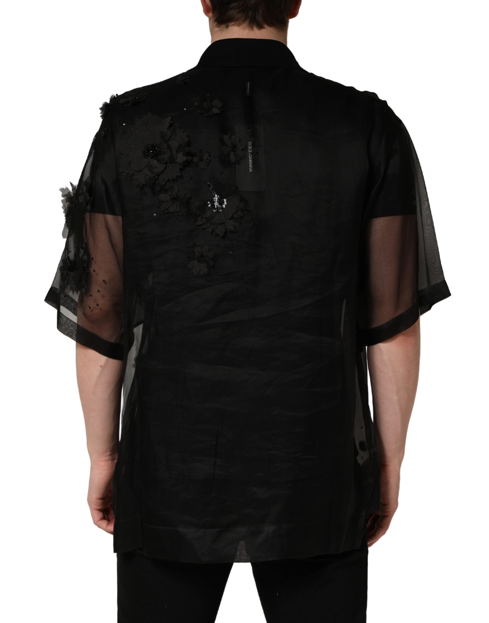Chemise courte en tulle noire Dolce & Gabbana avec appliqué floral transparent et manches courtes élégantes.