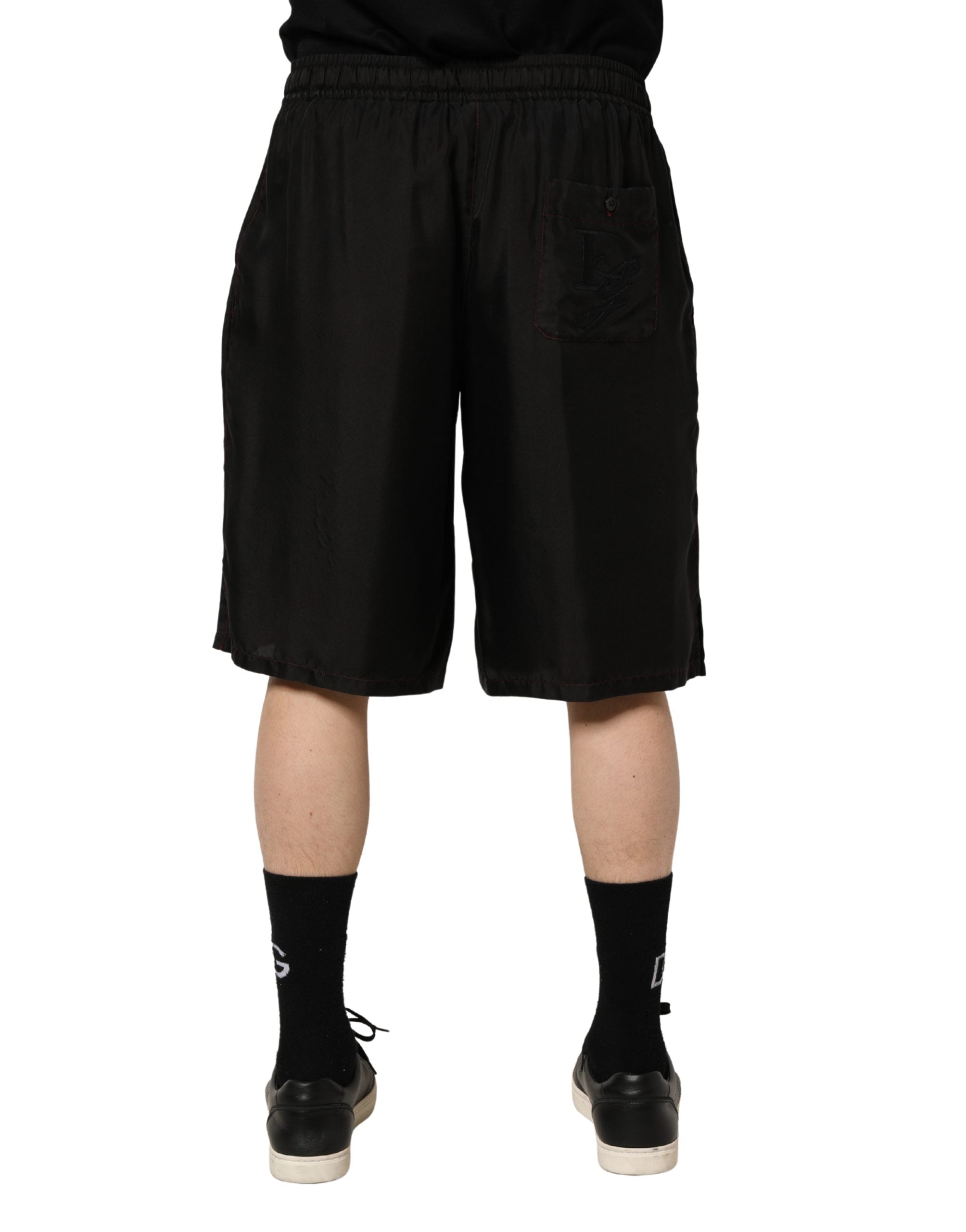 Shorts bermuda en soie noire pour homme de Dolce & Gabbana avec cordon de serrage, style élégant et confortable.