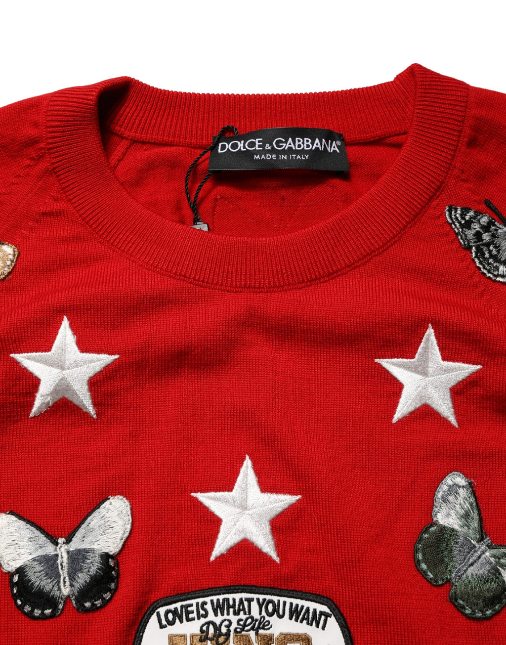 Pull homme Dolce & Gabbana en laine multicolore avec motif papillon et étoile, col ras du cou, style élégant et coloré.