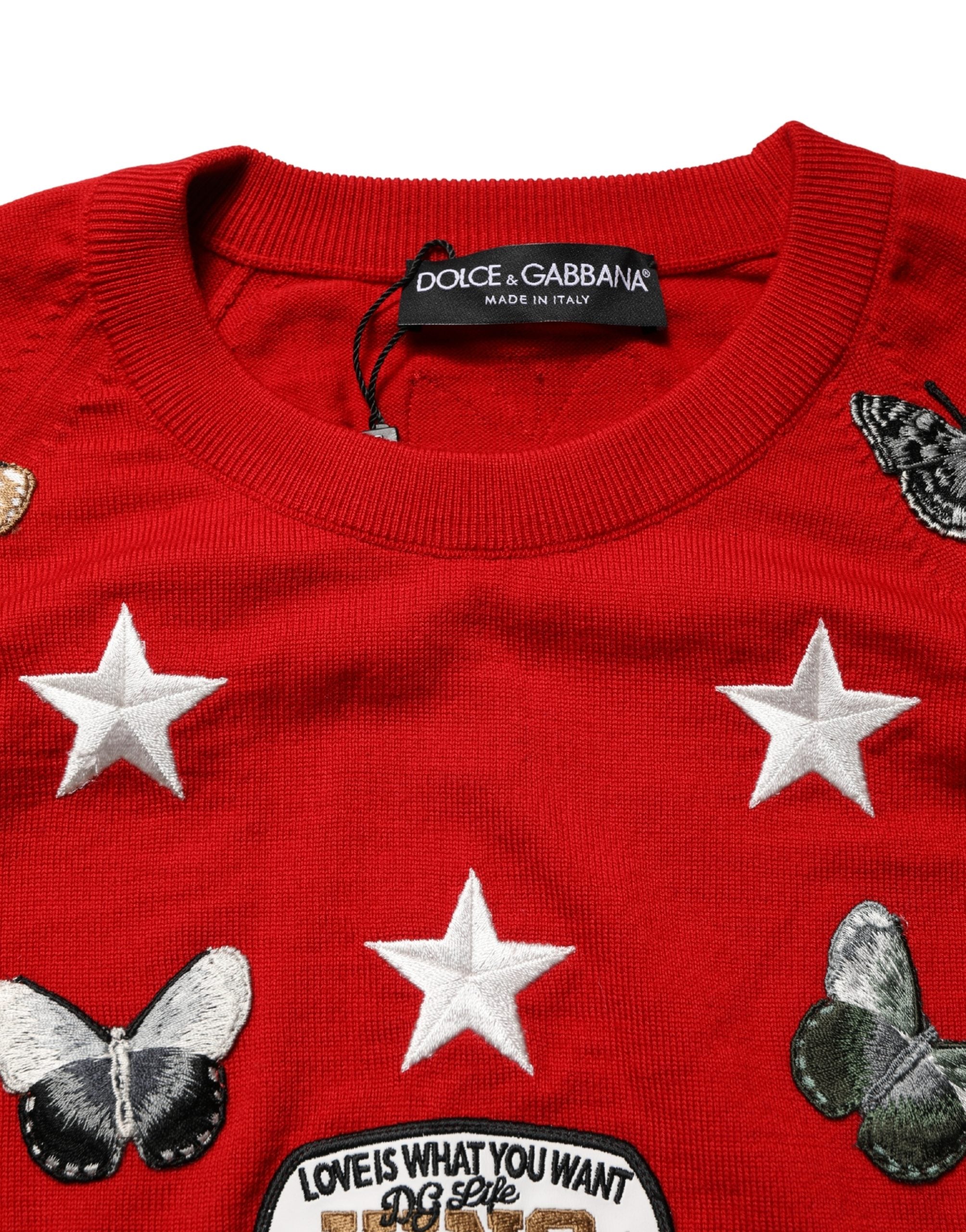 Pull homme Dolce & Gabbana en laine multicolore avec motif papillon et étoile, col ras du cou, style élégant et coloré.