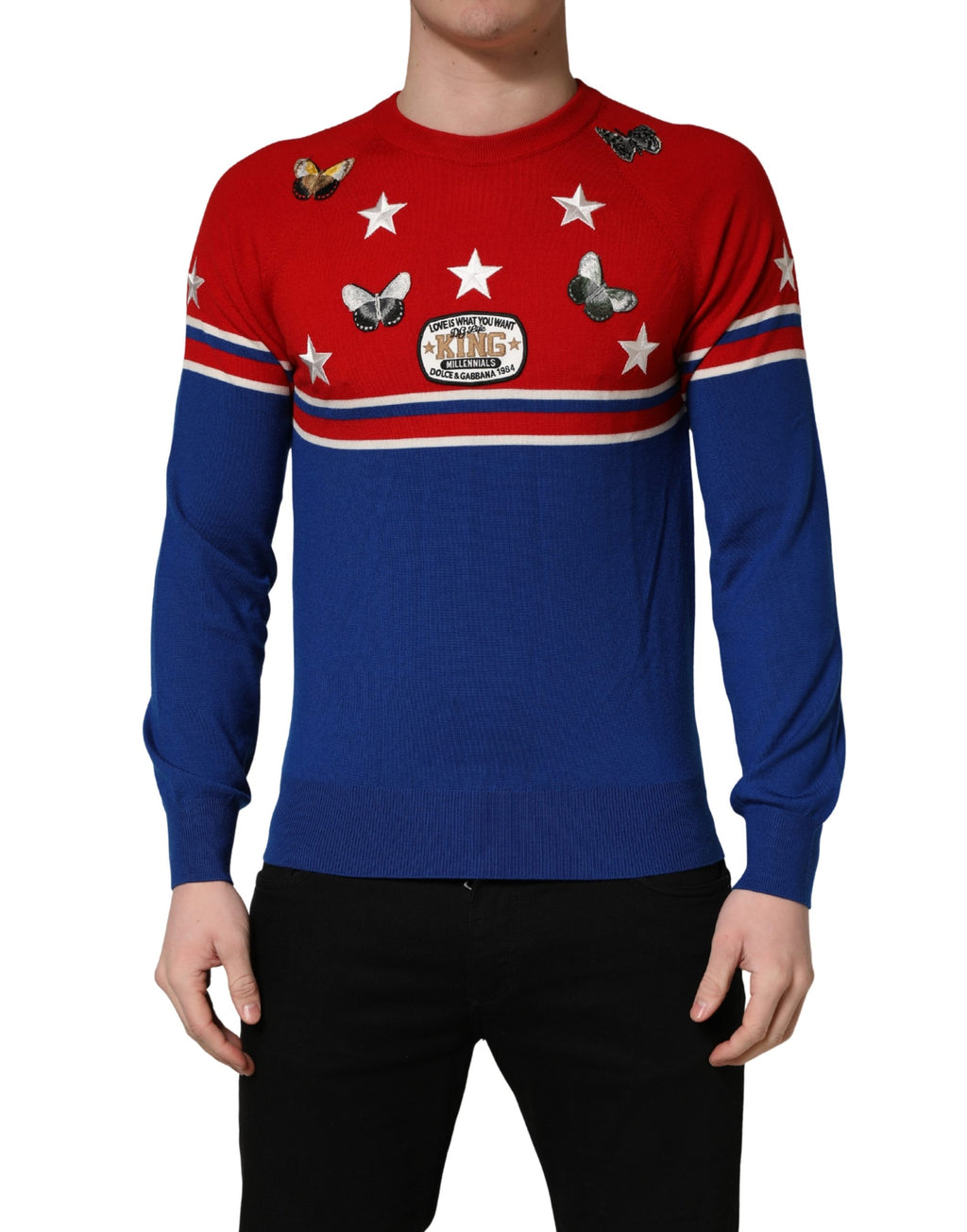 Pull homme Dolce & Gabbana en laine multicolore avec motif papillon et étoile, col ras du cou, détail coloré et élégant.
