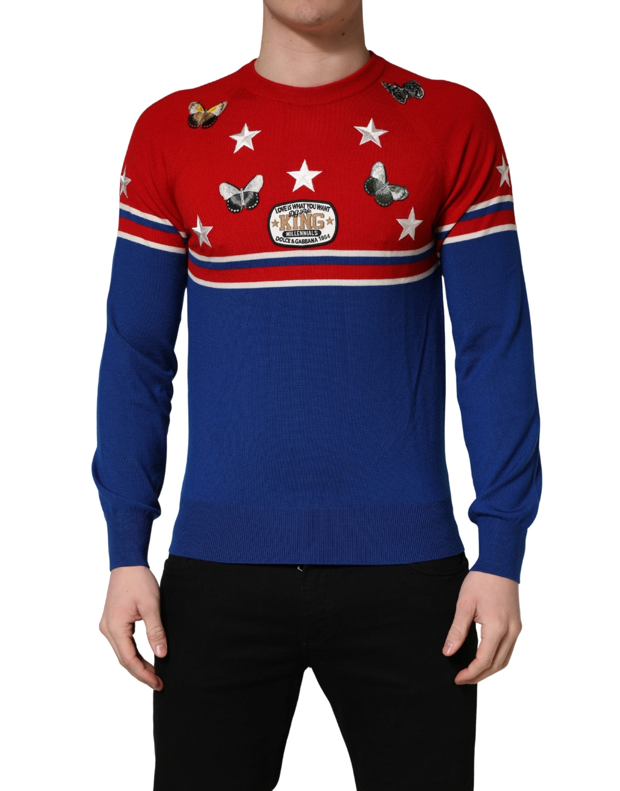 Pull homme Dolce & Gabbana en laine multicolore avec motif papillon et étoile, col ras du cou, détail coloré et élégant.
