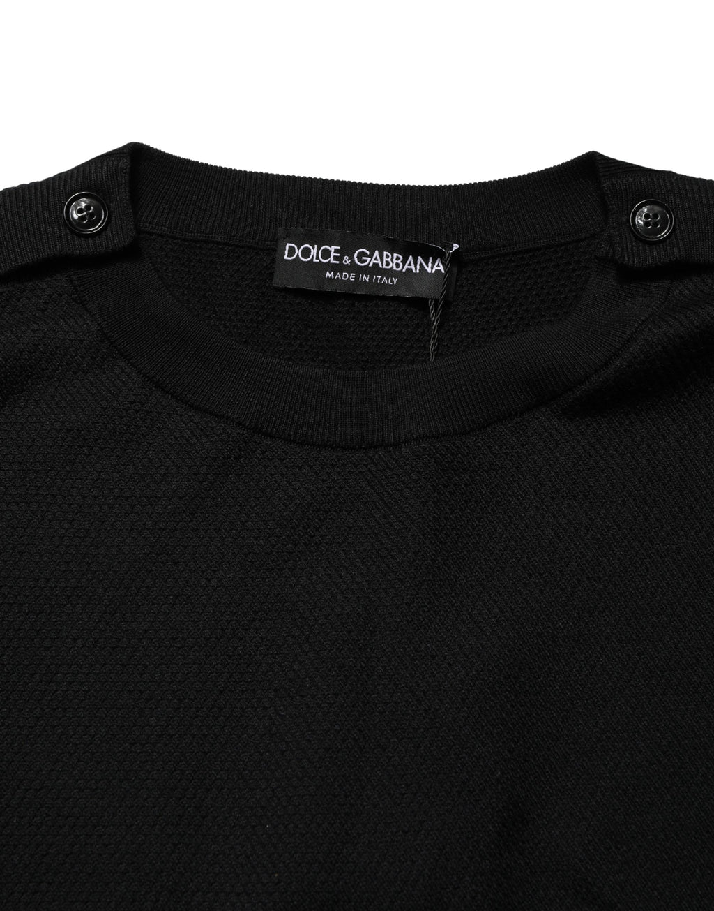Pull à manches longues noir Dolce & Gabbana avec col rond, coton doux et coupe classique, visible en détail dans l'image.