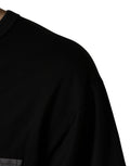 T-shirt oversize noir camouflage avec poche de la marque Dolce & Gabbana, design tendance et style décontracté.