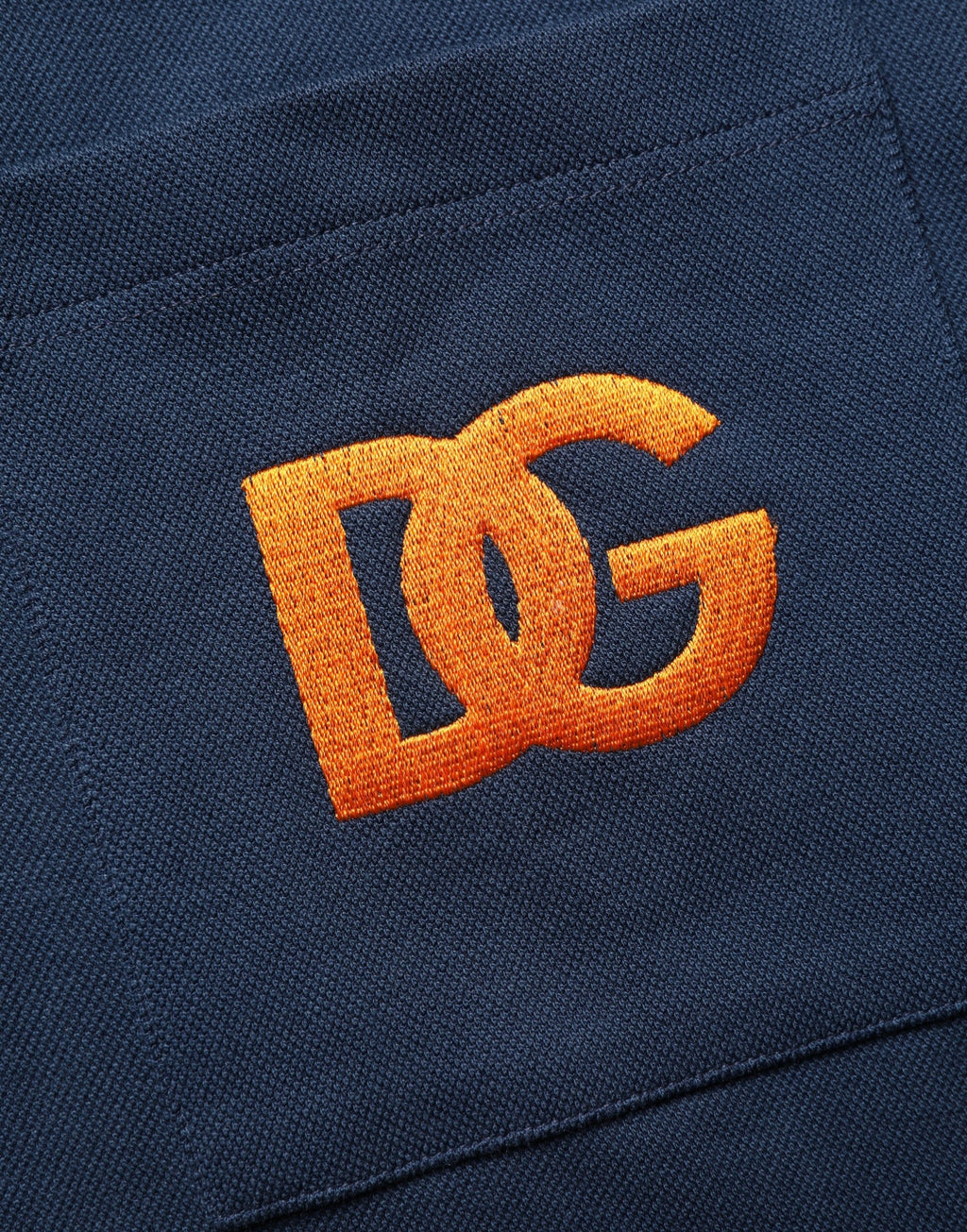Polo homme Dolce & Gabbana en coton bleu marine avec logo, manches courtes et design élégant.