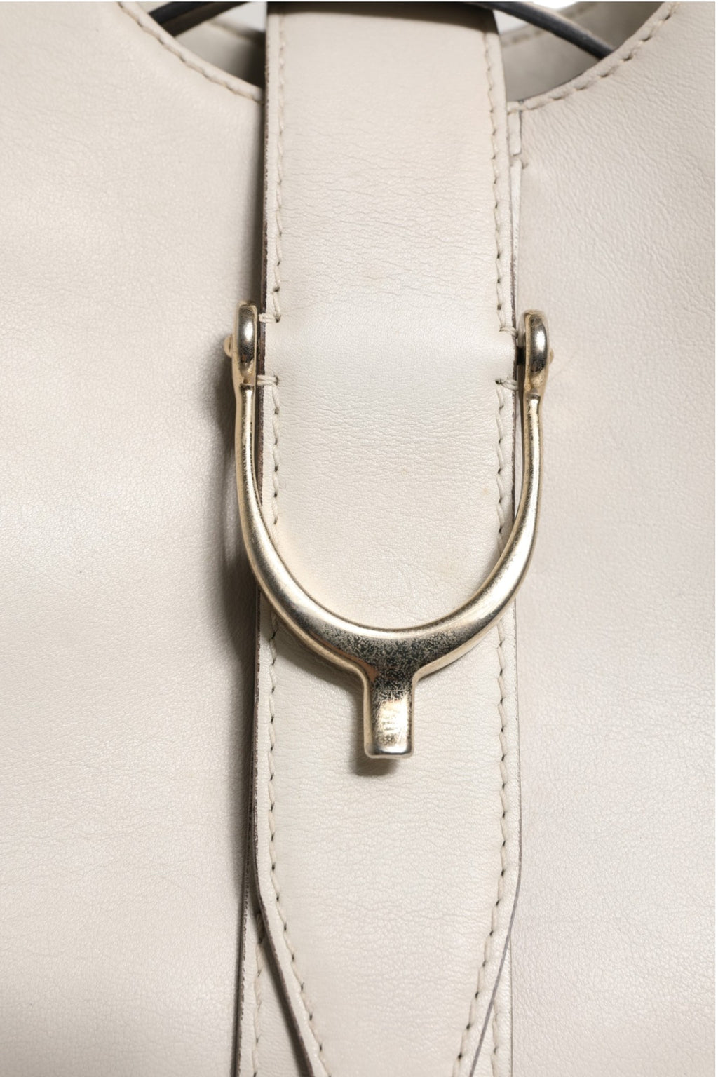 Sac à main Gucci blanc en cuir avec anse stirrup et poignée supérieure, élégant et sophistiqué.