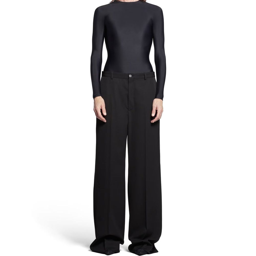 Pantalons évasés en laine noire de la marque Balenciaga, coupe fluide et tendance, visible sur cette image.