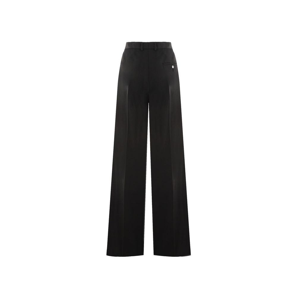 Pantalons évasés en laine noire Balenciaga, style tendance, avec coupe fluide et détails modernes, parfaits pour un look élégant.