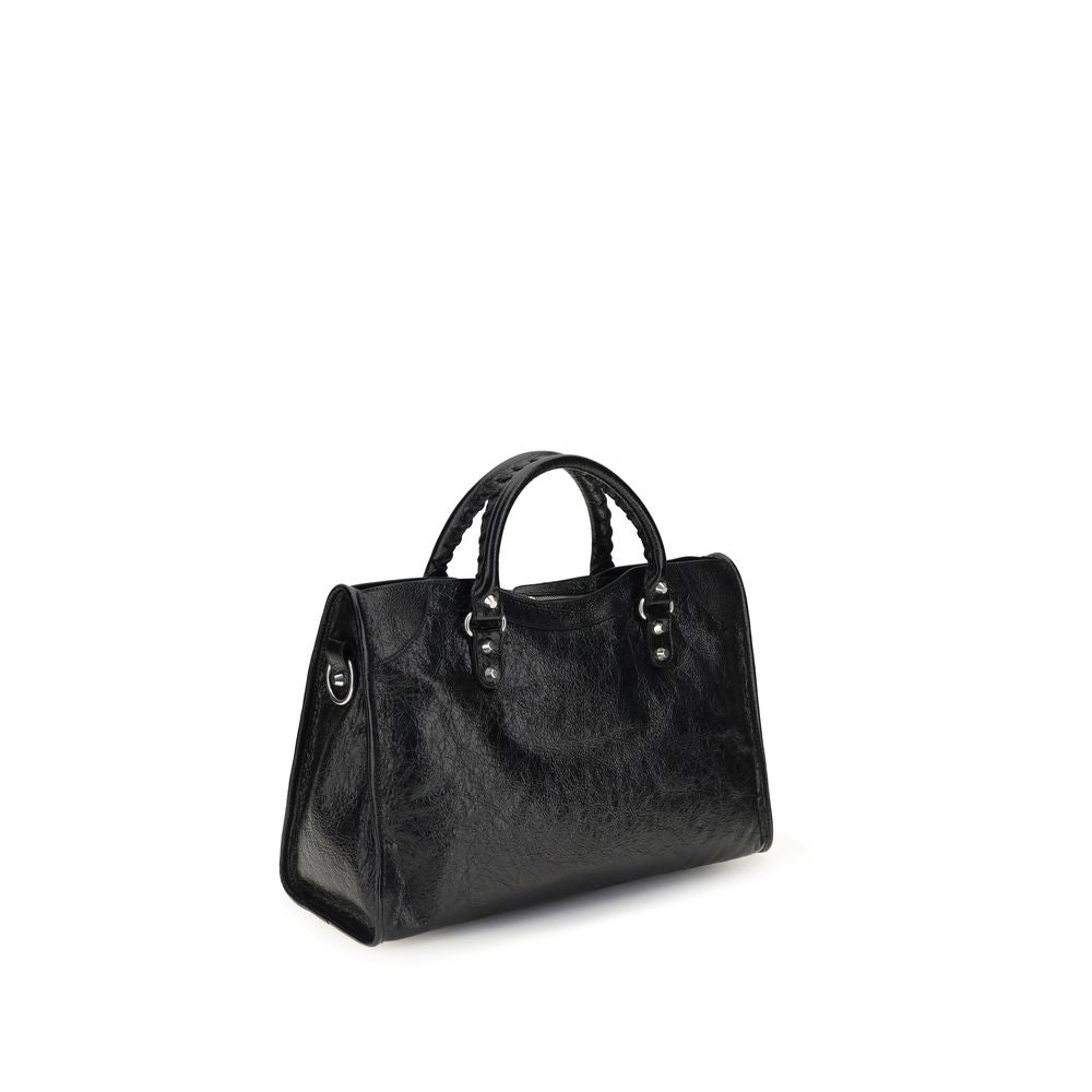 Sac à main Balenciaga en cuir d'agneau noir avec détails en or, style élégant et moderne, vue de face.