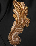 Sweat à capuche Dolce & Gabbana noir avec broderies, pompons et détails en franges, vue de face.