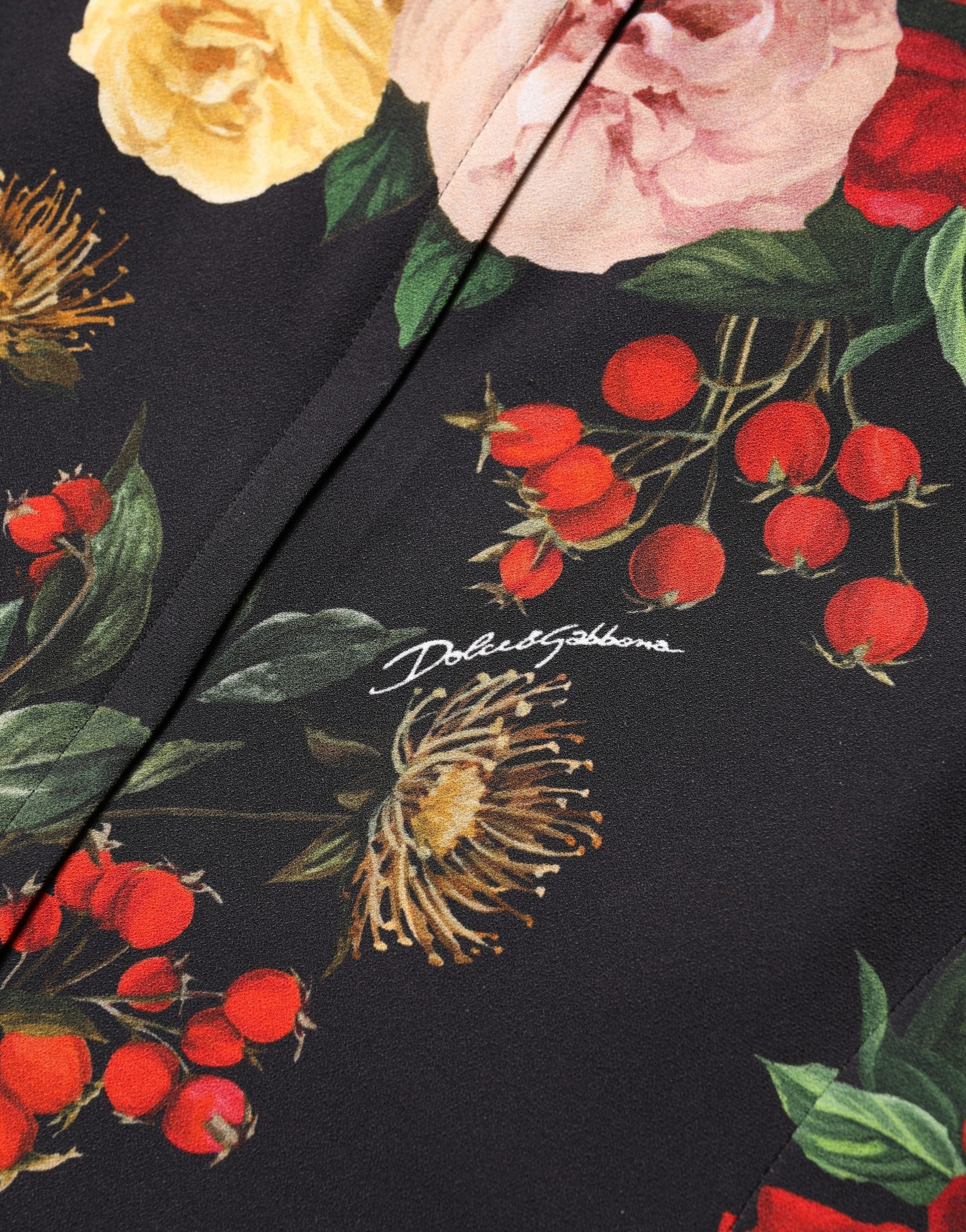 Blouse noire en crêpe Dolce & Gabbana avec détails en volants floraux et finition à fronces, style élégant et féminin.
