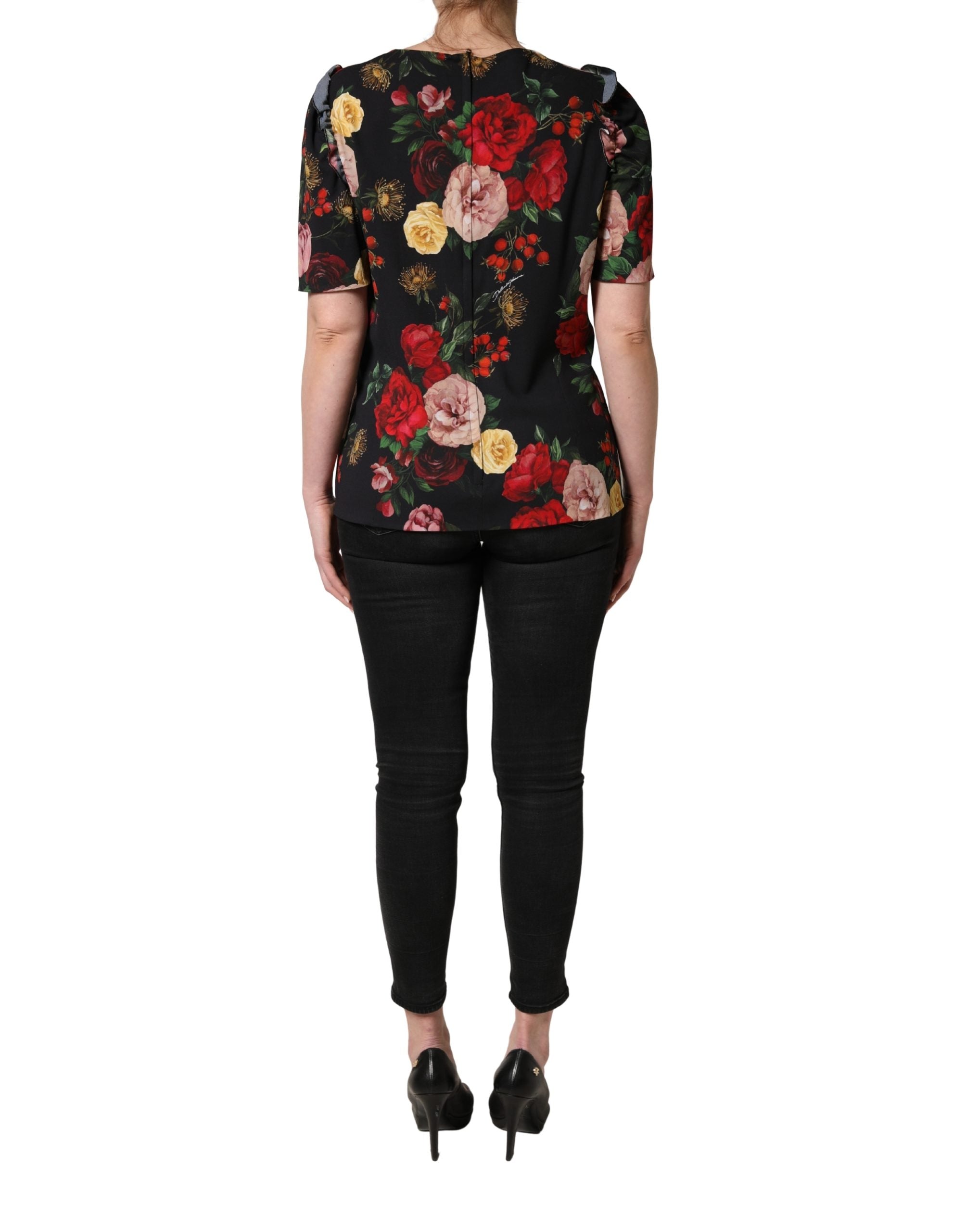Blouse noire Dolce & Gabbana en crêpe avec détails à volants et motifs floraux élégants.